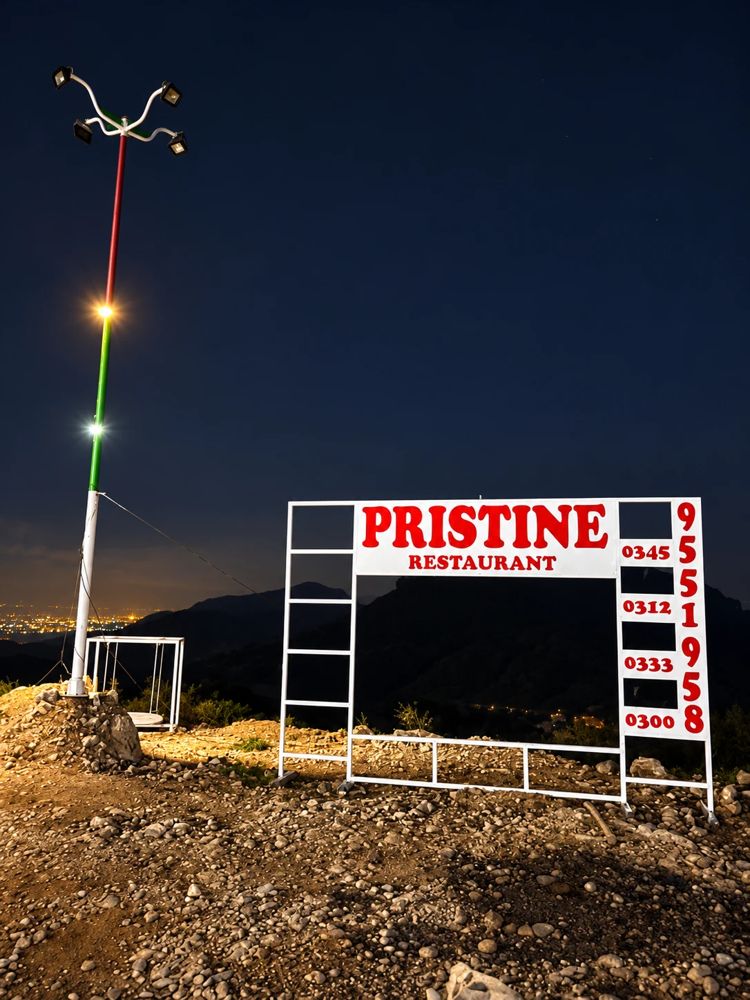 Pristine Restaurant sign with the city lights beyond